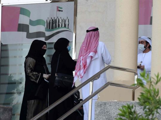 Dubai Court employees are seen at their office premises.