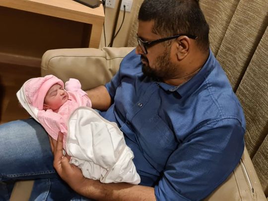 Khaleel Kadermon, 30 years old, an Indian from Kerala was stuck in Abu Dhabi when his wife had labour pain. His wife delivered the baby two days later after he reached Sharjah from Abu Dhabi during travel restriction. He hold his daughter, Khairah, who born on June 14. Supplied by the father. 