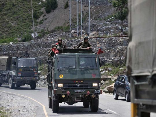 An Indian army convoy moves on the Srinagar- Ladakh highway at Gagangeer border China
