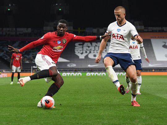 Manchester United's Paul Pogba, left, is challenged by Tottenham's Eric Dier during the English Premier League match in London.