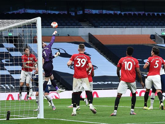 Manchester United's Spanish goalkeeper David de Gea punches the ball clear during the English Premier League football match between Tottenham Hotspur and Manchester United at Tottenham Hotspur Stadium in London, on June 19, 2020. (Photo by Glyn KIRK / AFP