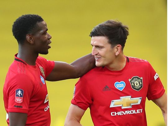 Manchester United's Harry Maguire is congratulated by Paul Pogba on his winner over Norwich
