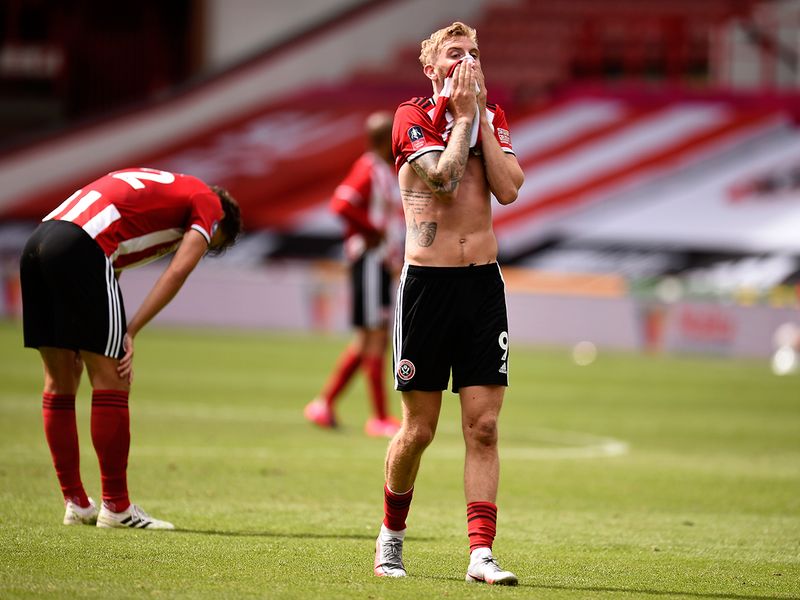Sheffield United's Oliver McBurnie, right, reacts after the FA Cup sixth round soccer match between Sheffield United and Arsenal at Bramall Lane in Sheffield, England, Sunday, June 28, 2020. (Oli Scarff/Pool via AP)