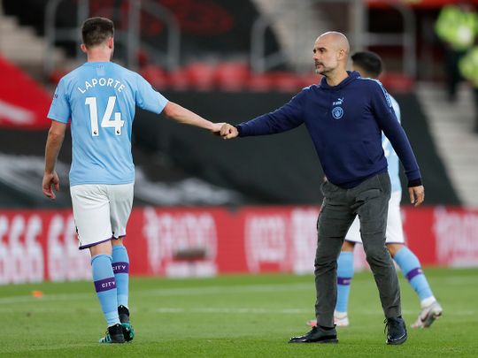 Manchester City's head coach Pep Guardiola with Aymeric Laporte.