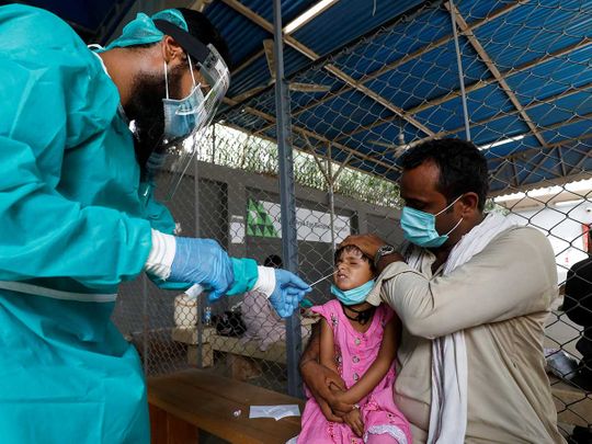 Nasal swab child Pakistan coronavirus protective gear