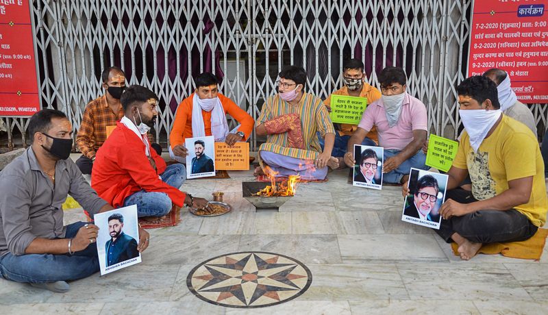 Ranchi: Fans of Bollywood mega star Amitabh Bachchan and his son Abhishek Bachchan perform 'hawan' for their speedy recovery from COVID-19, outside a temple in Ranchi, Sunday, July 12, 2020. (PTI Photo) (PTI12-07-2020_000056B)