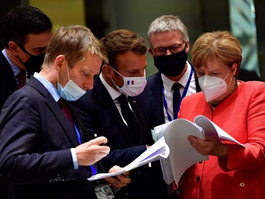 Spain's Prime Minister Pedro Sanchez (L), French President Emmanuel Macron (C) and German Chancellor Angela Merkel 