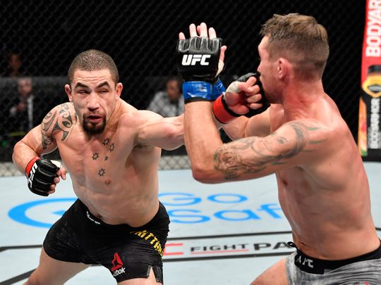 Robert Whittaker punches Darren Till in their middleweight fight during the UFC Fight Night event on UFC Fight Island.