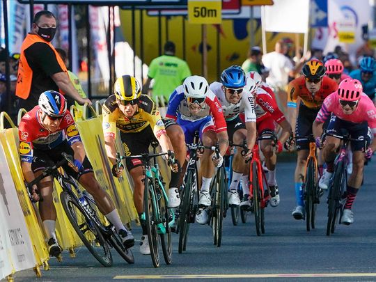 Dutch cyclist Fabio Jakobsen, left, hits side barriers after colliding with Dylan Groenewegen, 2nd left, on the final stretch of the opening stage of the Tour de Pologne 