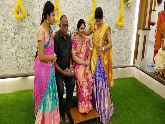 Srinivas Murthy with his wife's life size statue and daughters