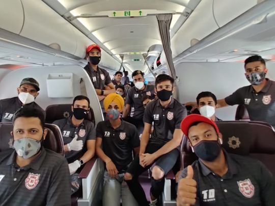Kings XI Punjab players wear their masks on the flight to the UAE