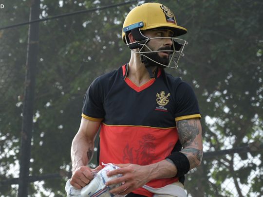 Viralt Kohli shows off his golden Royal Challengers Bangalore helmet in training in Dubai.