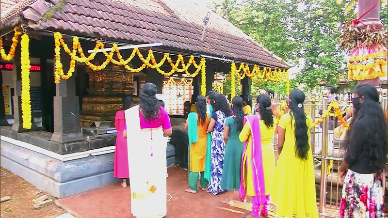 Devotees offering prayer on the occasion of Onam festival at the temple, in Kochi. 