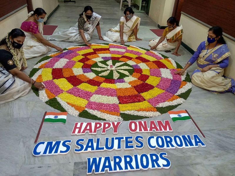 Keralite women make 'Pookolam' (flower decoration) on the occasion of Onam festival in Coimbatore. 