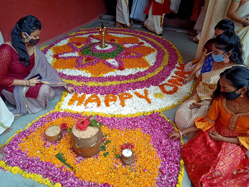 Women making flower rangoli on the ocassion of Onam, in Indore (Madhya Pradesh). 