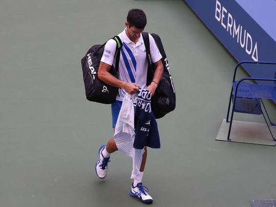 Novak Djokovic comes to the line judge's aid after hitting her with a ball at the US Open