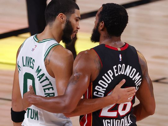 Jayson Tatum of the Boston Celtics congratulates Andre Iguodala of the Miami Heat 