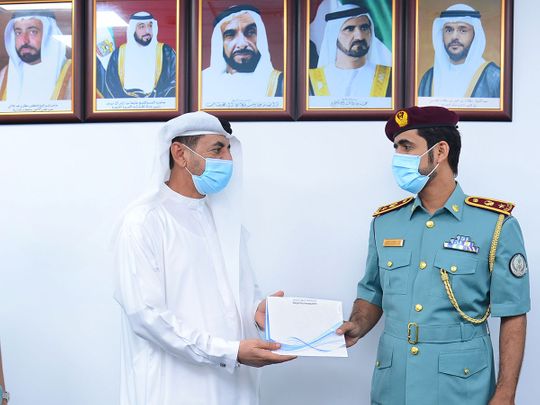 The watch being handed over to a family member of the Emirati woman who lost it