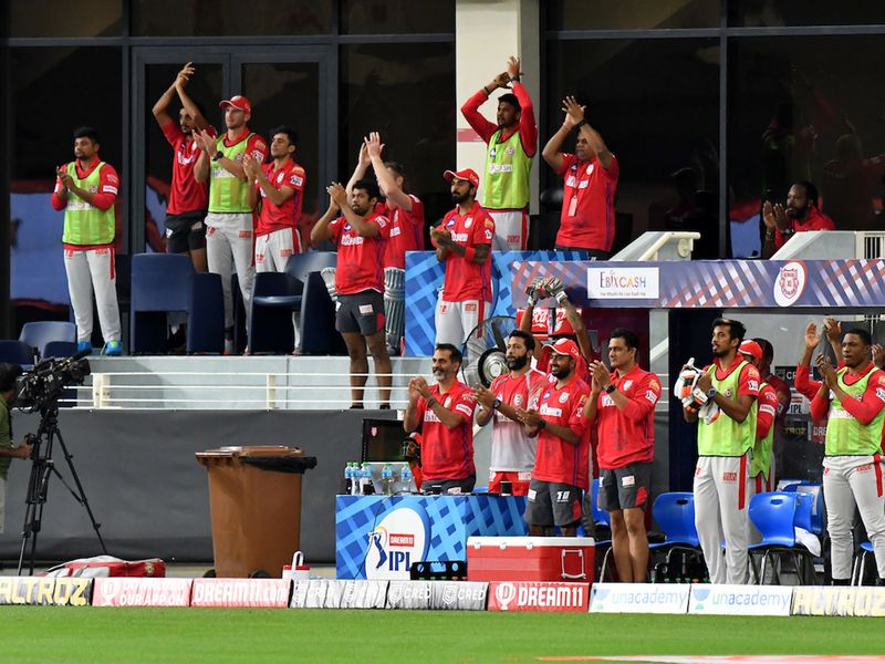 KXIP coaches, captain and team cheer Nicholas Pooran after he hit 50 runs during match 38 of season 13 of the Dream 11 Indian Premier League (IPL) between the Kings XI Punjab and the Delhi Capitals held at the Dubai International Cricket Stadium, Dubai in the United Arab Emirates on the 20th October 2020. Photo by: Samuel Rajkumar / Sportzpics for BCCI