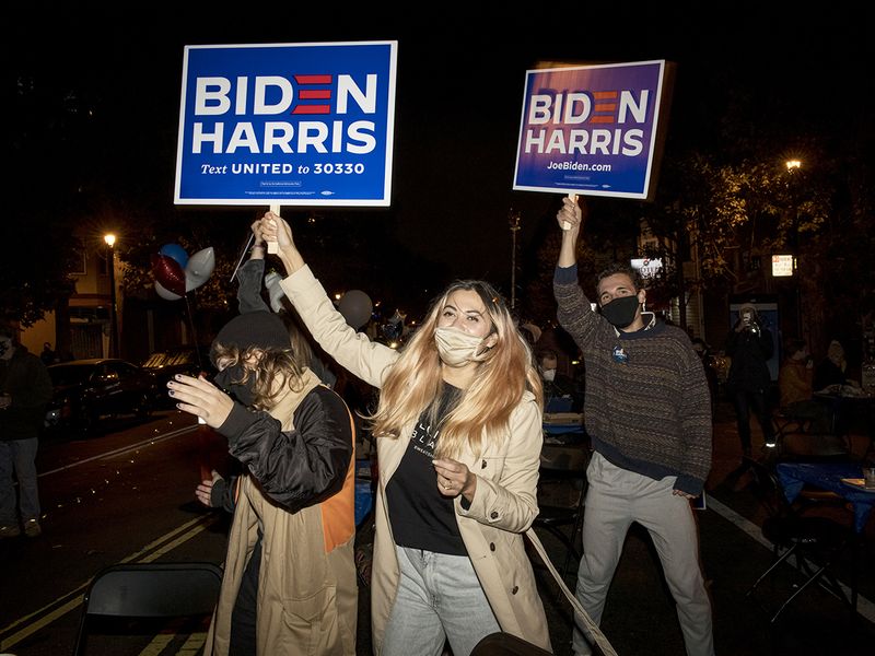 Attendees hold Biden Harris signs