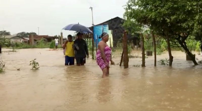 People wade in floodwaters caused by Hurricane Iota in Cartagena, Colombia. 