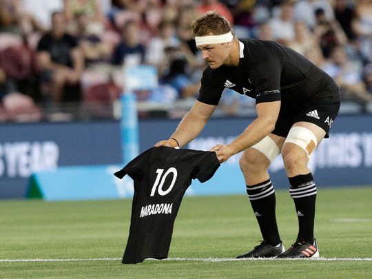 New Zealand All Blacks skipper Sam Cane lays a No. 10 shirt with Diego Maradona's name in the centre circle ahead of the Tri Nations match against Argentina Pumas