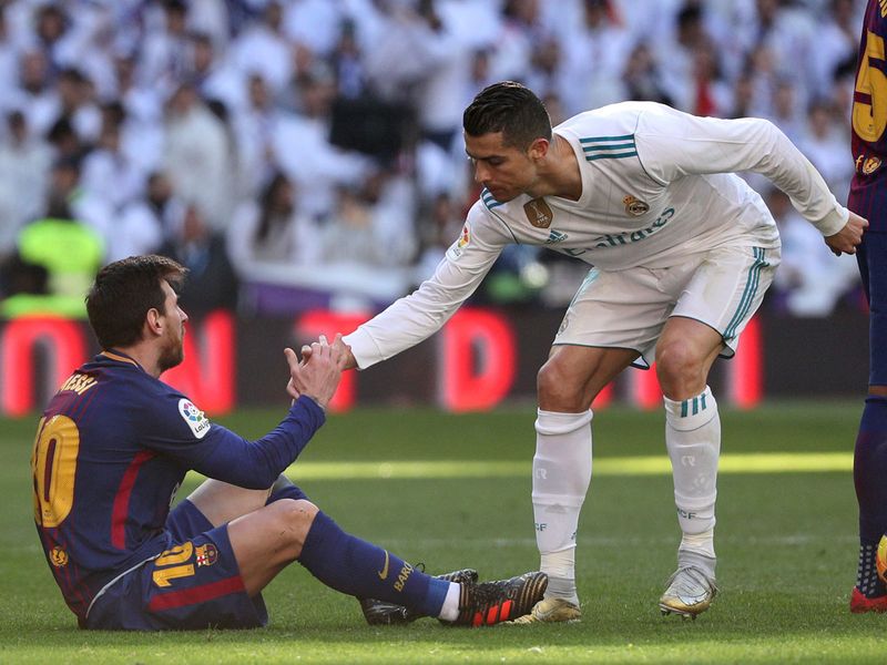 Cristiano Ronaldo helps Messi stand