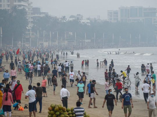 People visit Juhu Beach in the morning hours, in Mumbai