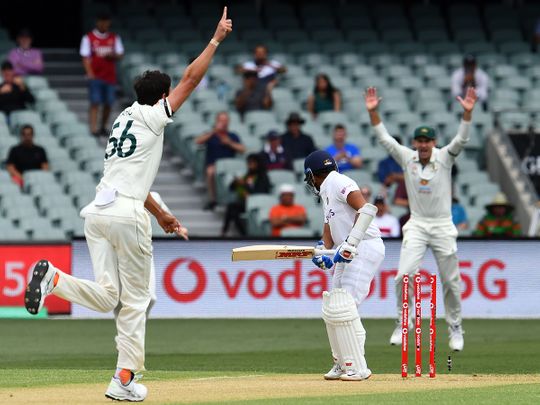 Australia's paceman Mitchell Starc celebrates his first wicket of India's batsman Prithvi Shaw on the first day of the cricket Test match between Australia and India in Adelaide.