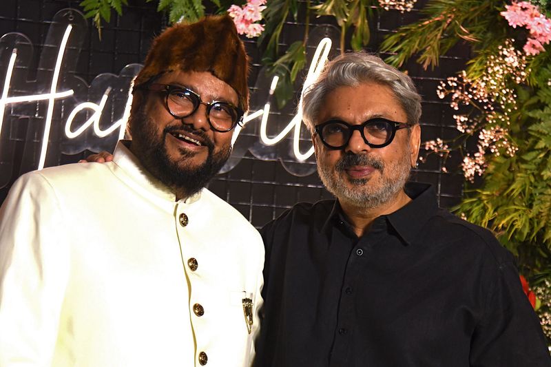 Bollywood music director and composer Ismail Darbar (L) and film director and producer Sanjay Leela Bhansali attend the wedding reception of actress Gauahar Khan and choreographer Zaid Darbar in Mumbai on December 25, 2020. (Photo by Sujit Jaiswal / AFP)