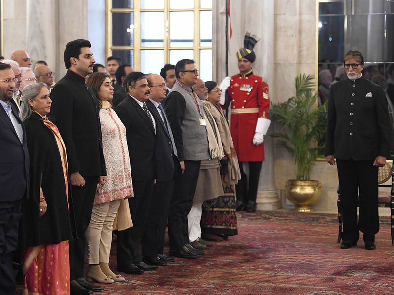 Amitabh Bachchan stands for the National Anthem along with Union Minister of Information and Broadcasting Prakash Javadekar, wife Jaya Bachchan (2nd L), son Abhishek Bachchan (3rd L) and other dignitaries before receiving Dadasaheb Phalke Award from President Ram Nath Kovind at Rashtrapati Bhavan in New Delhi. 