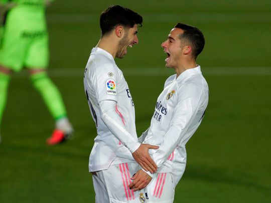 Real Madrid's Marco Asensio, left, celebrates with teammate Lucas Vazquez after scoring his side's second goal during the Spanish La Liga soccer match against Celta Vigo