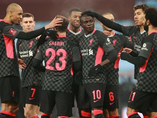 Liverpool celebrate Sadio Mane scoring his team's third goal during the English FA Cup third round football match against Aston Villa 