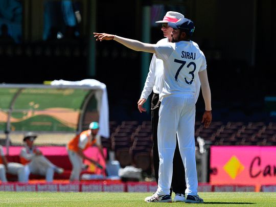 India's Mohammed Siraj gestures next to the umpire as the game was halted after allegedly some remarks were made by the spectators on the fourth day of the third cricket Test match between Australia and India at Sydney Cricket Ground.