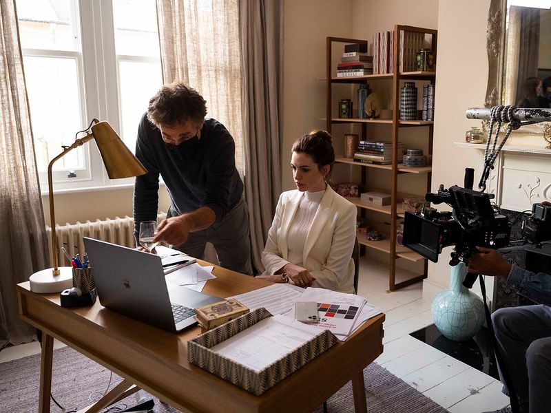 This image released by HBO Max shows director Doug Liman, left, with actress Anne Hathaway on the set of 