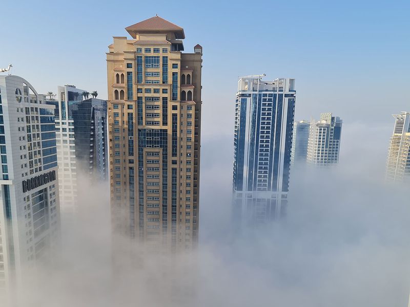 Fog covers building in Jumeirah Lake Towers