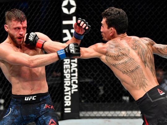 Max Holloway punches Calvin Kattar during UFC Fight Island 7 in Abu Dhabi