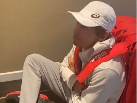 Alex de Minaur waits in vain for his transport to training at the Australian Open