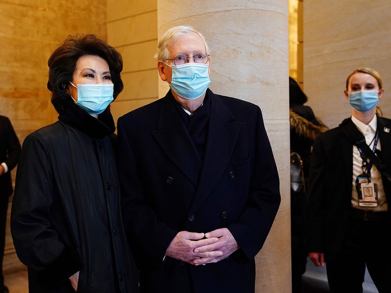 Senate Majority Leader Mitch McConnell (R) and former Secretary of Transportation Elaine Chao (L) arrives for the inauguration of Joe Biden, at the US Capitol in Washington, DC.  