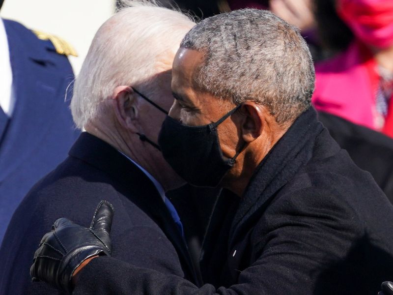 US President Joe Biden embraces former President Barack Obama after inauguration on the West Front of the US Capitol in Washington. 