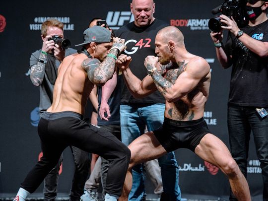 Dustin Poirier and Conor McGregor face-off at the weigh-in on Yas Island