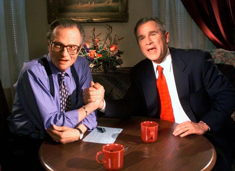 In this Dec. 16, 1999 file photo, Republican presidential candidate Texas Gov. George W. Bush jokes with CNN's Larry King after finishing the 