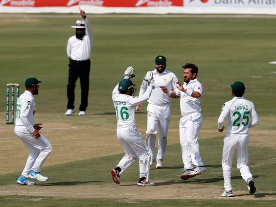 Pakistan's spinner Yasir Shah, second from right, celebrates with teammates on the dismissal of South Africa's Faf du Plessis