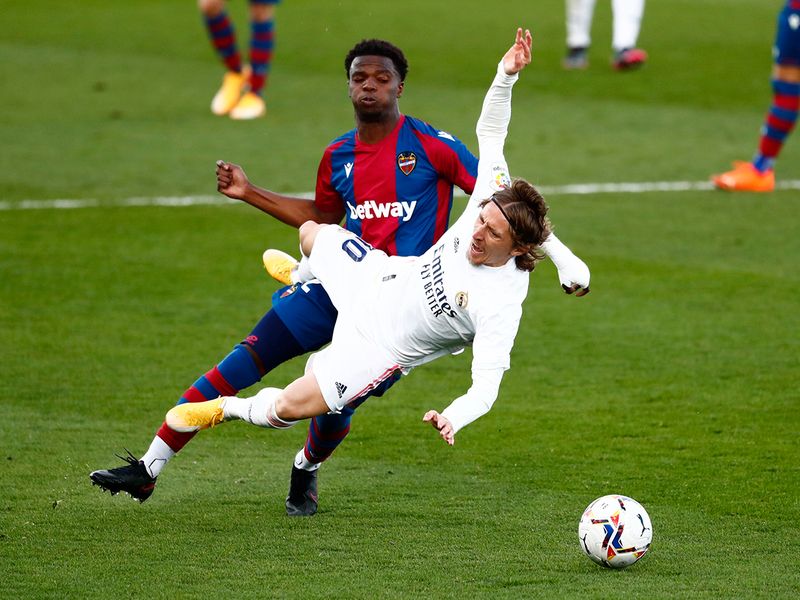 Real Madrid's Luka Modric in action with Levante's Mickael Malsa.