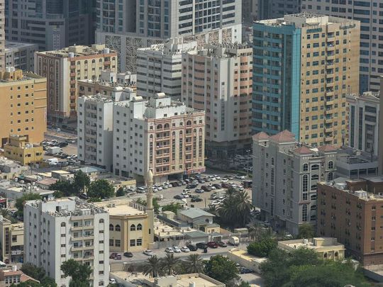 Stock Ajman skyline taxi bus street