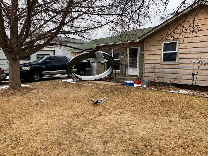 Debris is scattered in the front yard of a house at near 13th and Elmwood, Saturday, Feb. 20, 2021, in Broomfield, Colo. 