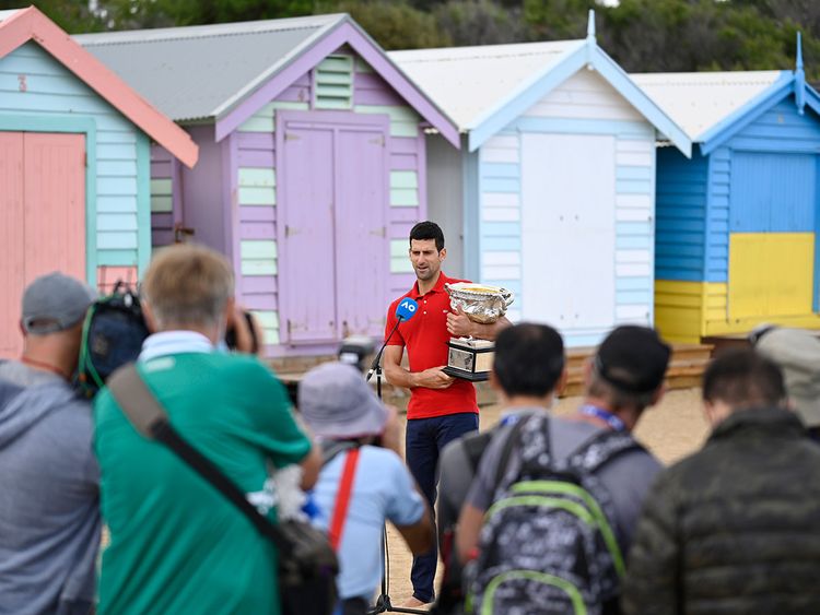 Novak Djokovic with the Australian Open trophy at Brighton Beach in Melbourne