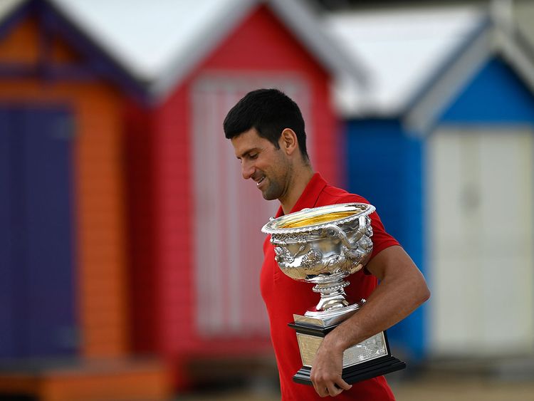 Novak Djokovic with the Australian Open trophy at Brighton Beach in Melbourne