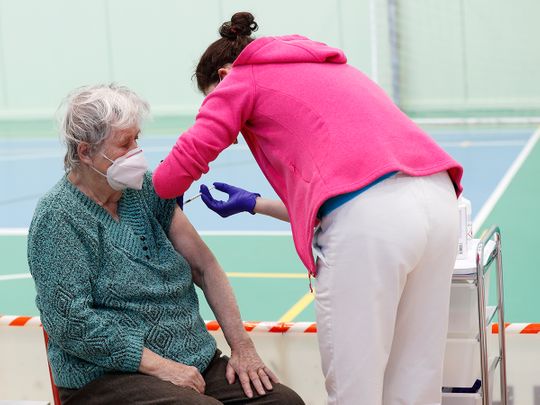 An elderly woman receives Moderna COVID-19 vaccine at a sports hall in Ricany, Czech Republic. 