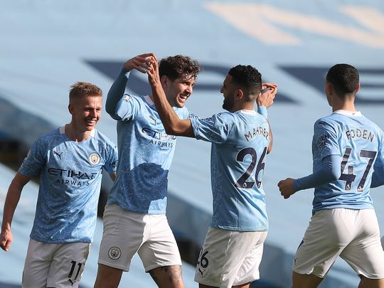 Manchester City's John Stones celebrates with teammates after scoring the winner against West Ham